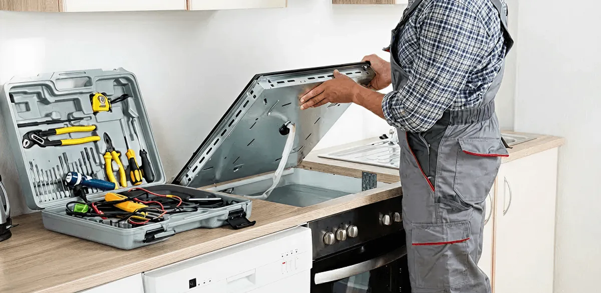 Handyman repairing a cooktop and checking wiring connections in Pasadena, CA