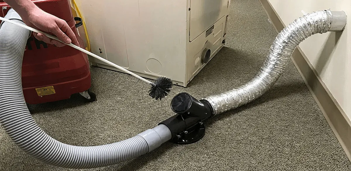 Dryer vent cleaning service removing lint from a dryer duct connection in Pasadena, CA