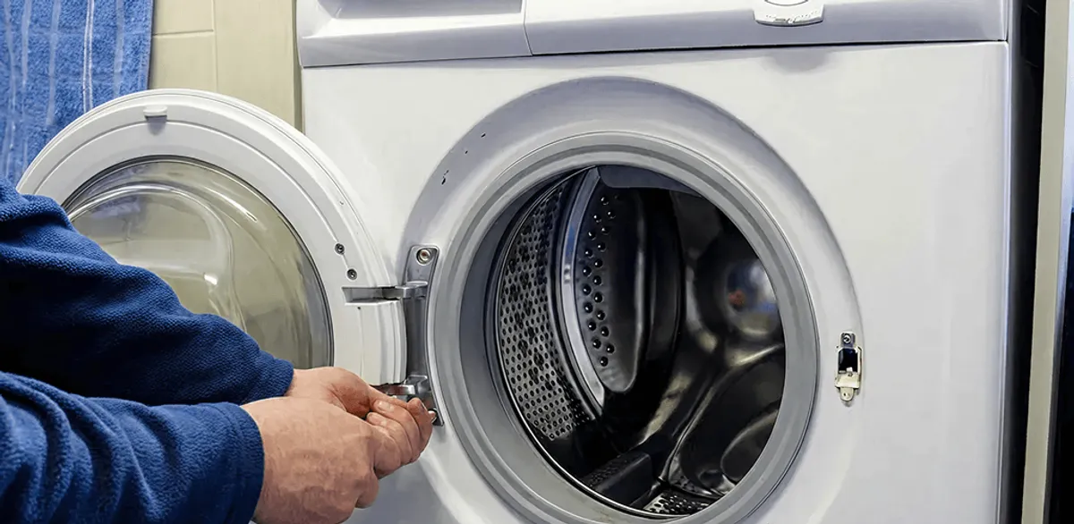 Washing machine repair handyman checking a front-load washer door and latch in Pasadena, CA