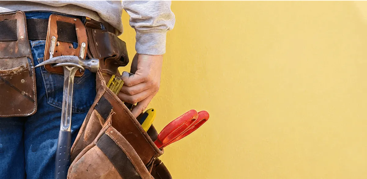 Handyman with tool belt ready for home repairs and maintenance in Pasadena, CA