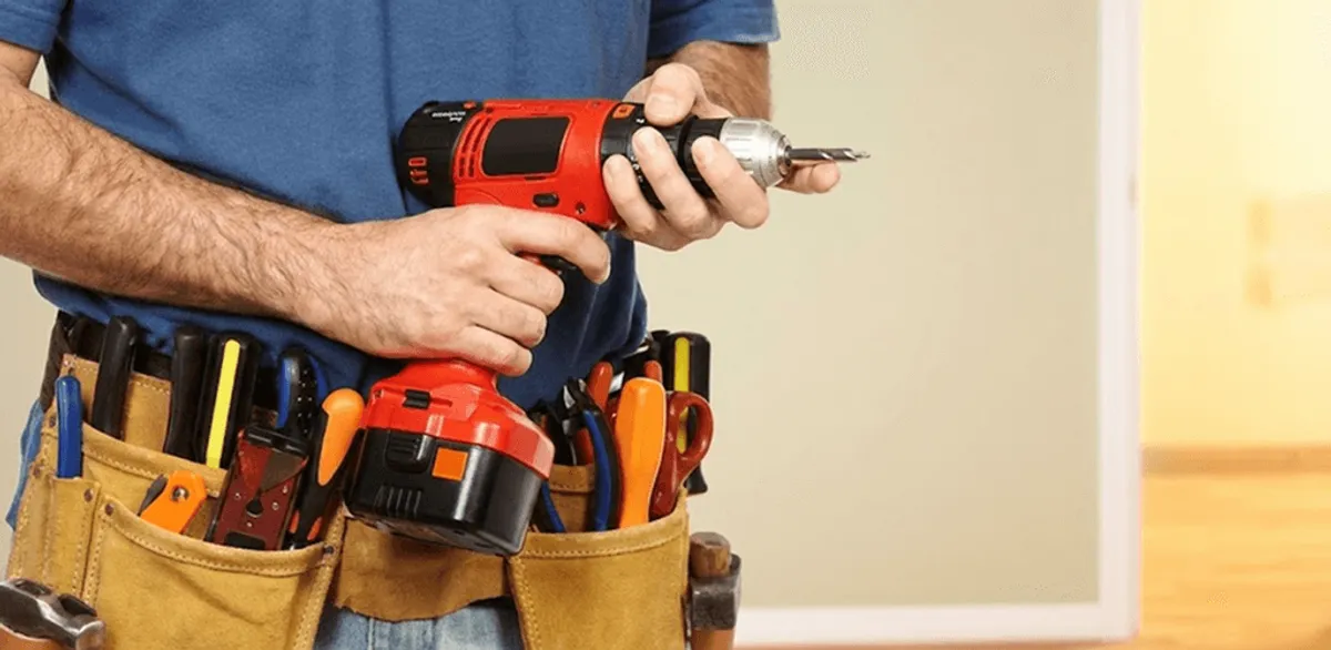 Handyman holding a power drill for home repairs and installations in Pasadena, CA