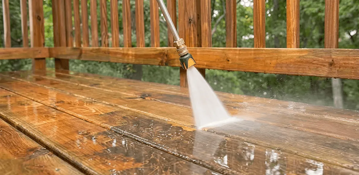 Pressure washing a wood deck to remove dirt and buildup in Pasadena, CA