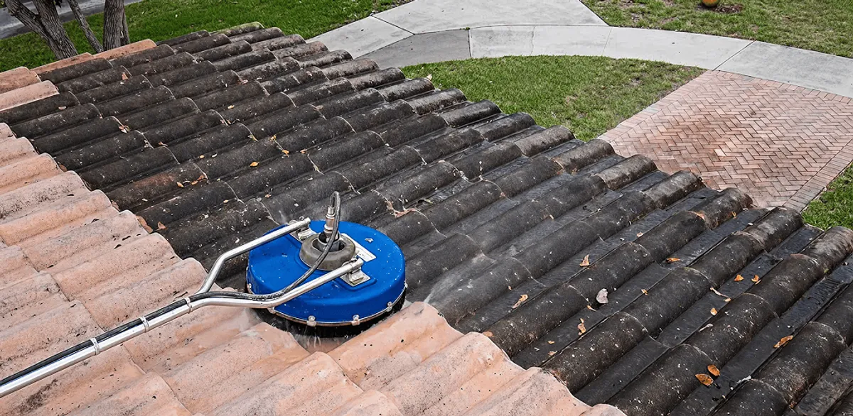 Roof pressure cleaning removing debris and buildup from roof tiles in Pasadena, CA