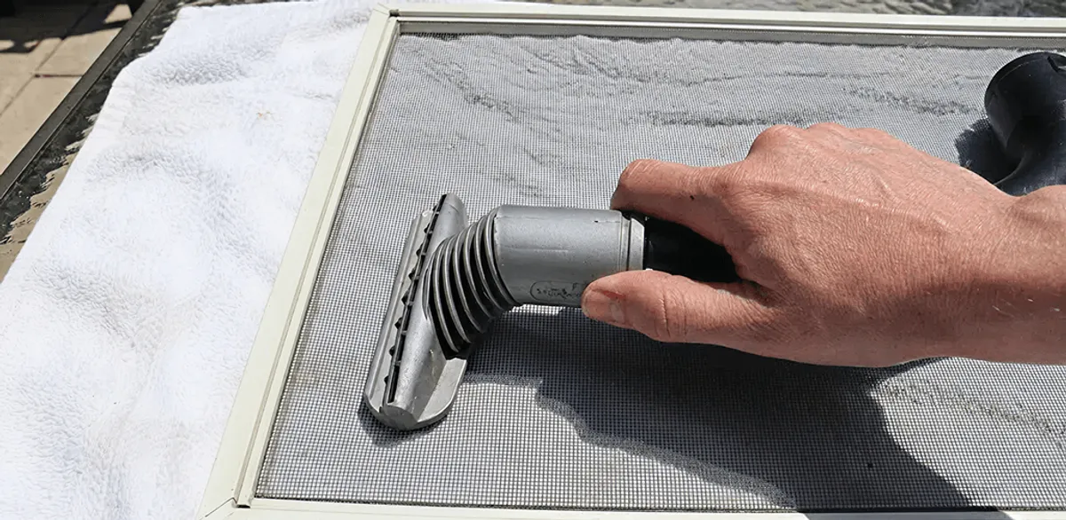 Window screen repair cleaning and fixing a damaged screen mesh in Pasadena, CA